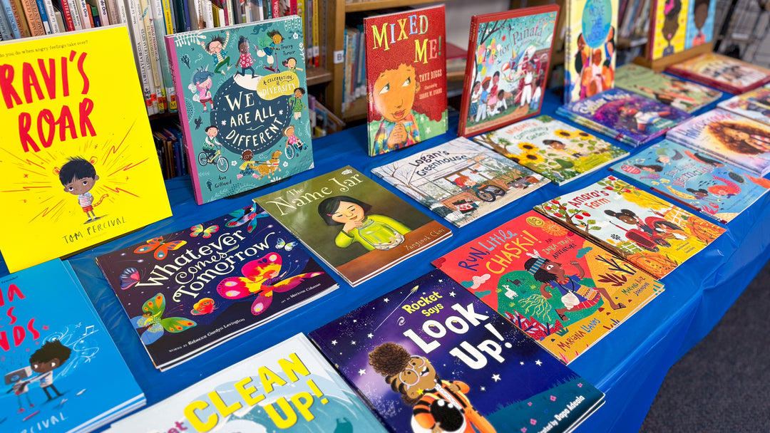 Children selecting books at a Mija Books fair